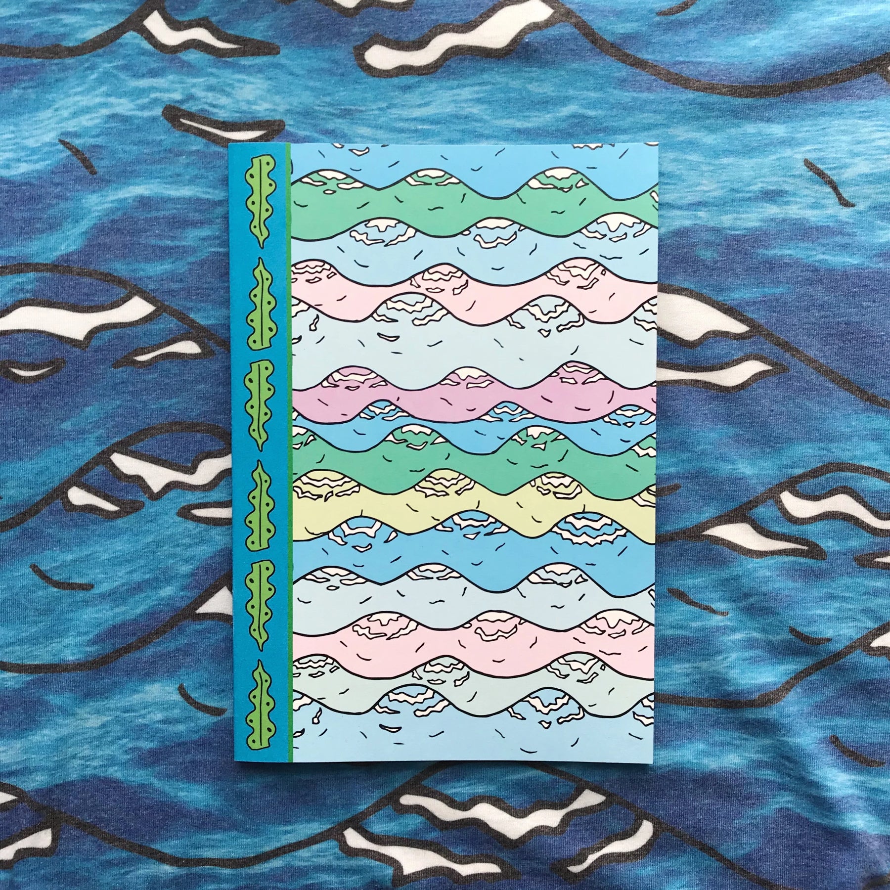 Merpola A5 Notebook &#39;Let Me Sea Your Doodle&#39; featuring pastel wave illustration design and seaweed boardar