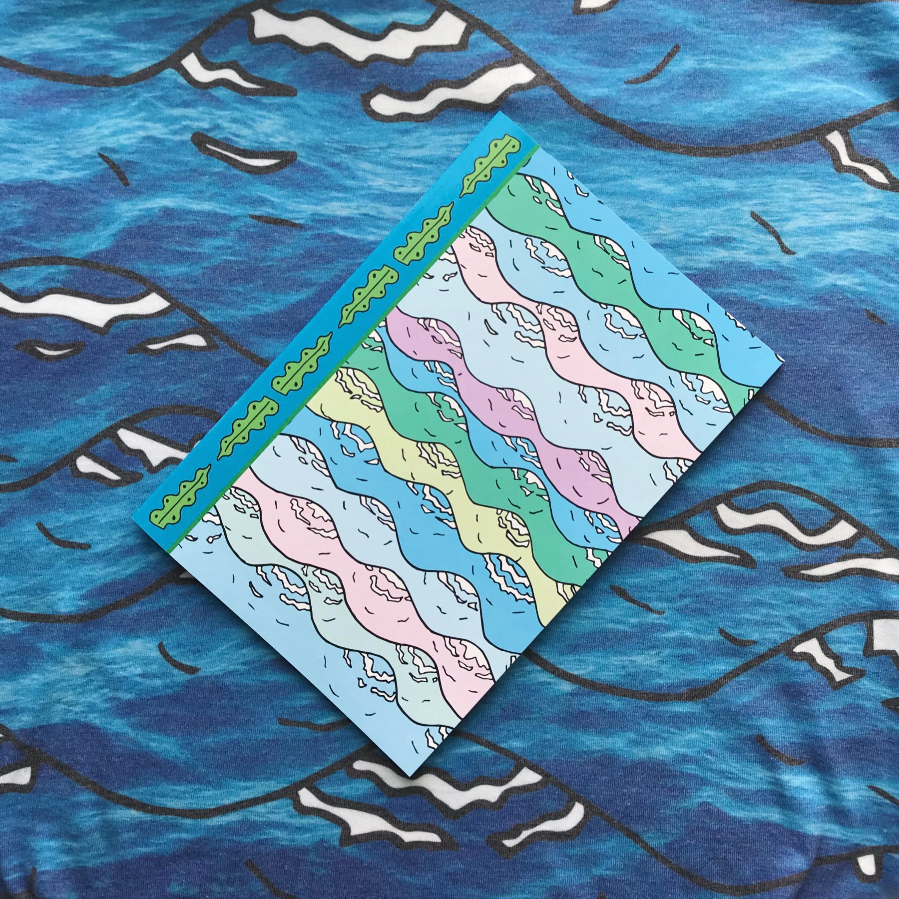 Merpola A5 Notebook &#39;Let Me Sea Your Doodle&#39; featuring pastel wave illustration design and seaweed boardar
